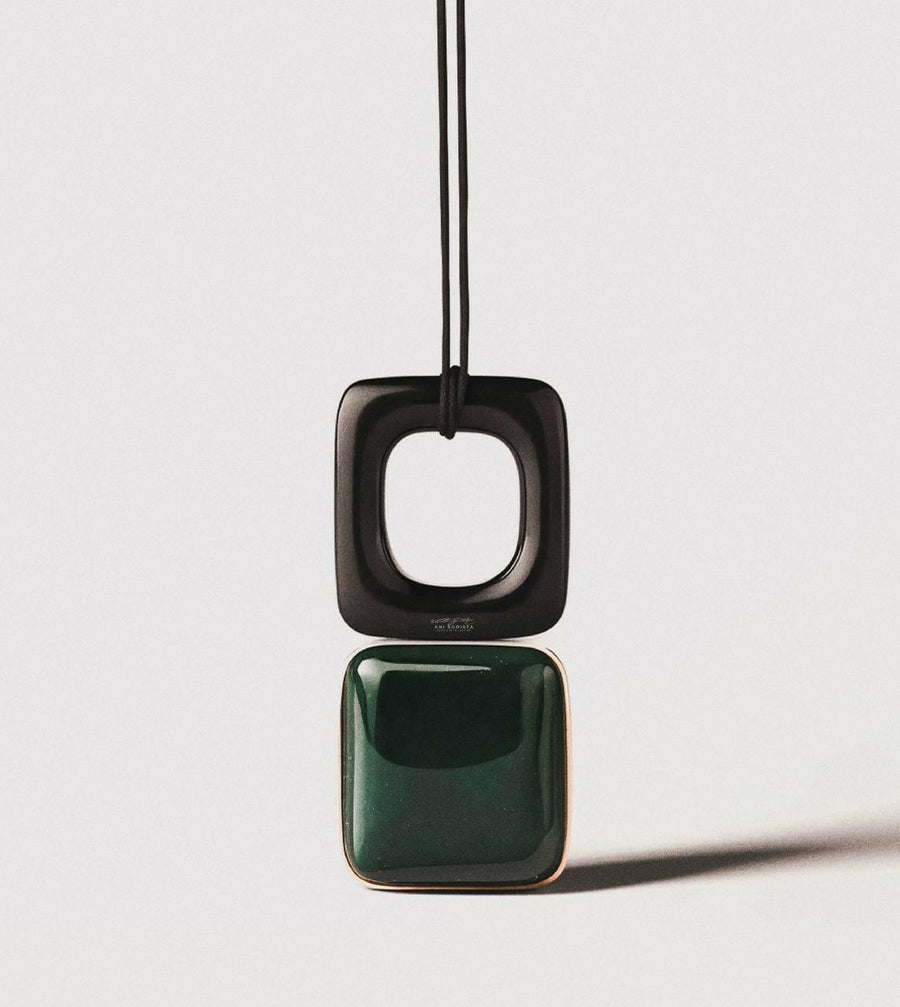 A sophisticated black necklace with a geometric pendant suspended on a slender cord, from ANI EGOISTA’s Framed Essence collection. The pendant features a square frame with a high-quality polymer construction that exudes modern simplicity.